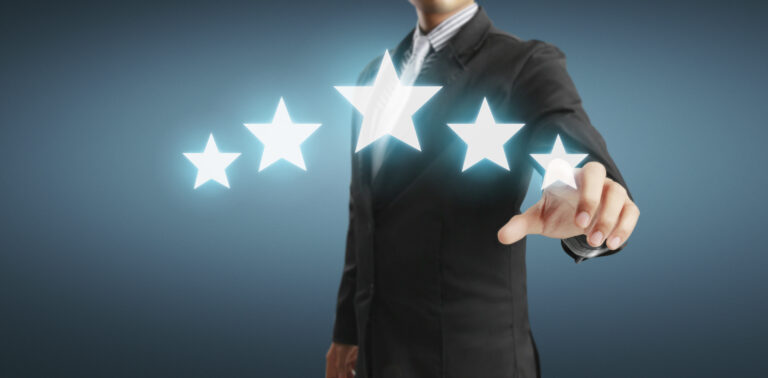 A man in a suit behind five stars.